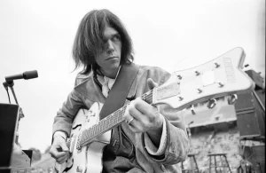 Neil Young playing an electric guitar